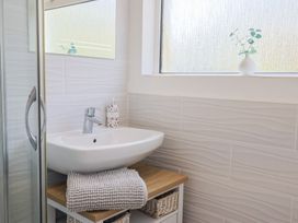 A bathroom with a sink and shower at Fluta in Seaton