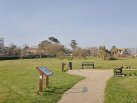 A park with benches and information boards at Fluta Seaton