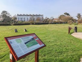 An outdoor area with a sign and grass at Fluta in Seaton