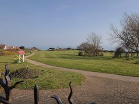 A view of a garden with a path and flowers at Fluta in Seaton