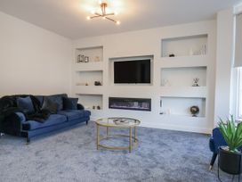 A living room with a sofa and a television at 2 bed Scarborough