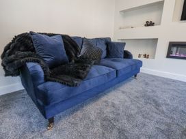 A sofa with pillows and a blanket in a living room at 2 bed Scarborough