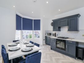 A kitchen with a dining area and modern appliances at 2 bed Scarborough