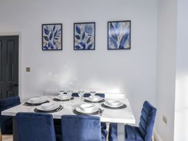 A dining room with a table set for six at 2 bed in Scarborough