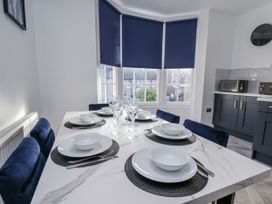 A dining room with a table set for dinner at 2 bed in Scarborough