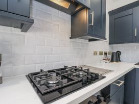 A kitchen with a gas stove and kettle at 2 bed in Scarborough