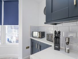 A kitchen with a microwave and knife block at 2 bed in Scarborough