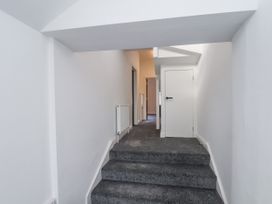 A staircase in a hallway at 2 bed Scarborough