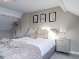 A bedroom with a bed and nightstand at 2 bed Scarborough