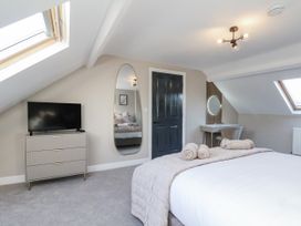 A bedroom with a bed and television at 2 bed in Scarborough