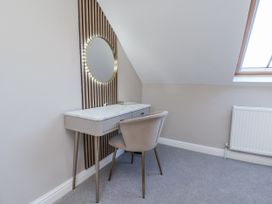 A dressing area with a vanity table and mirror at 2 bed in Scarborough