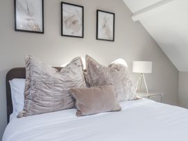 A bedroom with pillows and a lamp at 2 bed in Scarborough