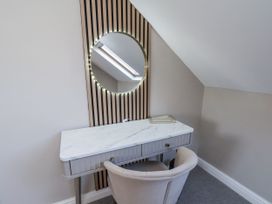 A bedroom with a vanity desk and mirror at 2 bed, Scarborough