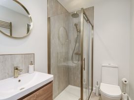 A bathroom with a shower and sink at 2 bed in Scarborough