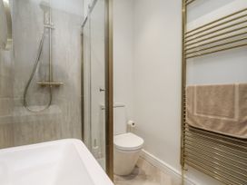 A bathroom with a shower and bathtub at 2 bed in Scarborough