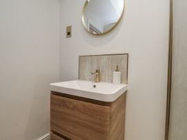 A bathroom with a sink and mirror at 2 bed Scarborough