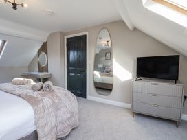 A bedroom with a bed and television at 2 bed in Scarborough