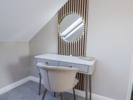 A vanity desk with a chair and a mirror at 2 bed in Scarborough