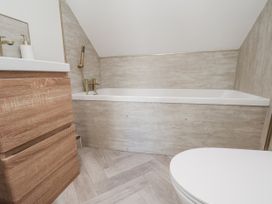 A bathroom with a bathtub and sink at 2 bed in Scarborough