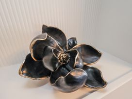 A decorative black flower sculpture at 2 bed in Scarborough
