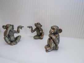 Three monkey figurines depicting different poses at a residence in Scarborough