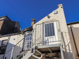 An exterior view of a building with a metal staircase leading to a door in Scarborough