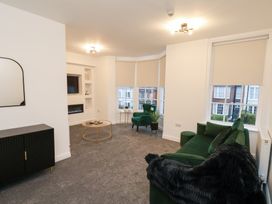 A living room with a sofa and coffee table at Maxwell View in Scarborough