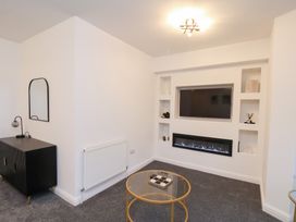 A living room with a television and electric fireplace at Maxwell View in Scarborough