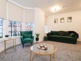 A living room with green furniture and a coffee table at Maxwell View in Scarborough
