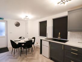 A kitchen with a table and chairs at Maxwell View in Scarborough