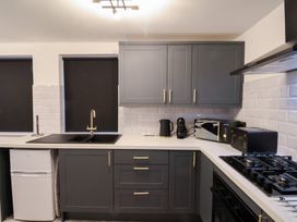 A kitchen with cabinets, sink, kettle, and microwave at Maxwell View in Scarborough