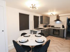A kitchen with a dining table and kitchen appliances at Maxwell View in Scarborough