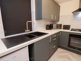 A kitchen with a sink and appliances at Maxwell View in Scarborough