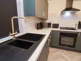 A kitchen with a sink and appliances at Maxwell View in Scarborough