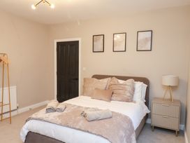 A bedroom with a bed and bedside table at Maxwell View in Scarborough
