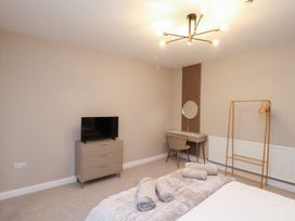 A bedroom with a bed and dresser at Maxwell View in Scarborough