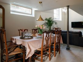 A dining room with a table and chairs at The School House in Newton Abbot