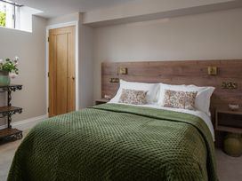 A bedroom with a bed and bedside table at The School House in Newton Abbot