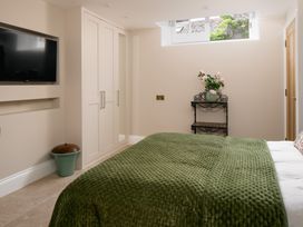 A bedroom with a bed and a television at The School House in Newton Abbot