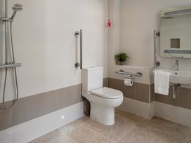 A bathroom with a shower, toilet, sink, and bathtub at The School House in Newton Abbot