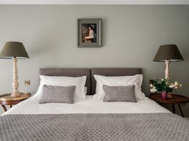 A bedroom with a bed and lamps at The School House in Newton Abbot