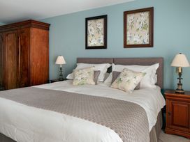 A bedroom with a bed and wardrobe at The School House in Newton Abbot