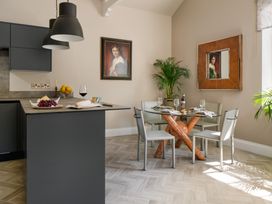A dining room with a glass table and chairs at Upper School House in Newton Abbot