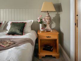 A bedroom with a bed and nightstand at Upper School House in Newton Abbot