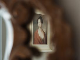 A painting of a woman reflected in a decorative mirror at Upper School House in Newton Abbot