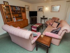 A living room with sofas and a coffee table at Grange Cottage in Belford