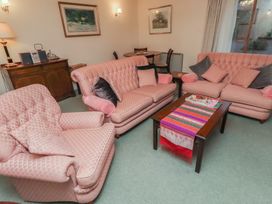 A living room with sofas and a coffee table at Grange Cottage in Belford