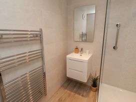 A bathroom with a towel rail and sink at Grange Cottage in Belford