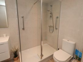 A bathroom with a shower and toilet at Grange Cottage in Belford