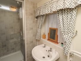A bathroom with a shower and sink at Grange Cottage in Belford